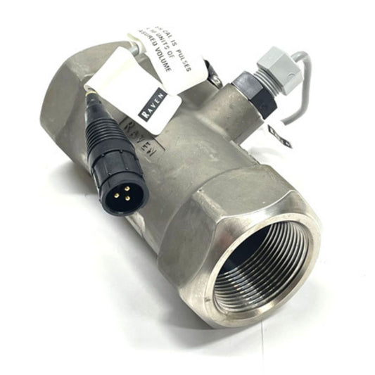 The Raven RFM 60S High Pulse Stainless Flow Meter for NH3 applications, with a flow rate ranging from 1 to 60 GPM and featuring 1-1/2" FPT threaded ends, includes a three-pin connector and labels. It is constructed from stainless steel and isolated against a white background.