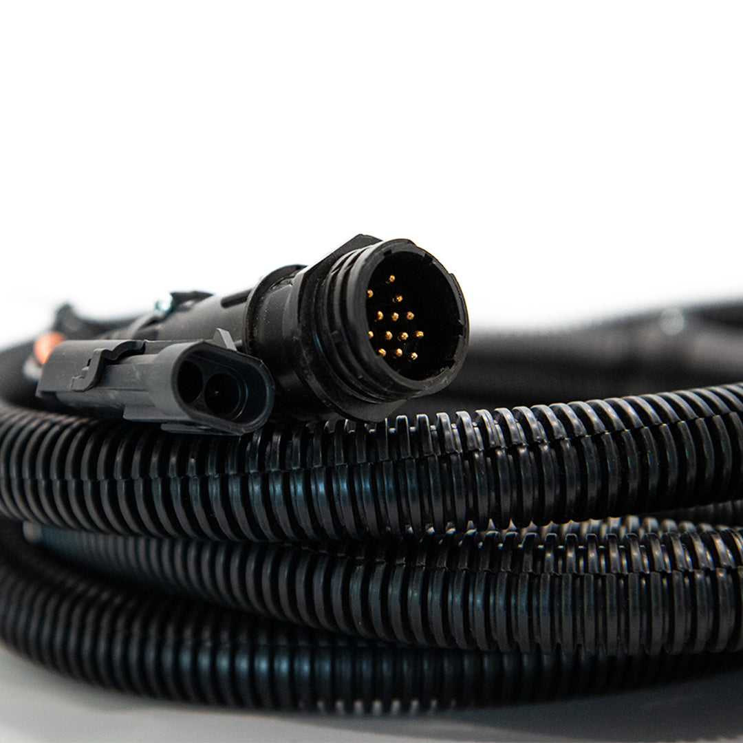 Close-up of the Raven 10' Product Cable for DCS 400, featuring a black coiled design and multi-pin connector, on a white background.