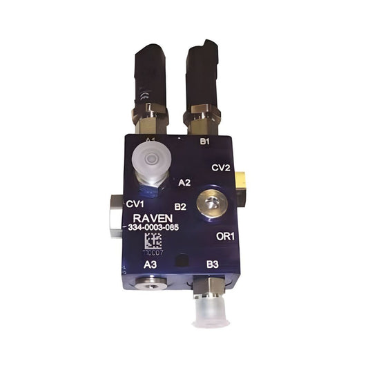 Close-up of a Raven Hydraulic Override Flow Switch with Fittings (334-0003-085), showing various labeled ports, connectors, and valves against a white background, highlighting its compatibility with the Case IH Patriot 250 for precision agricultural applications.