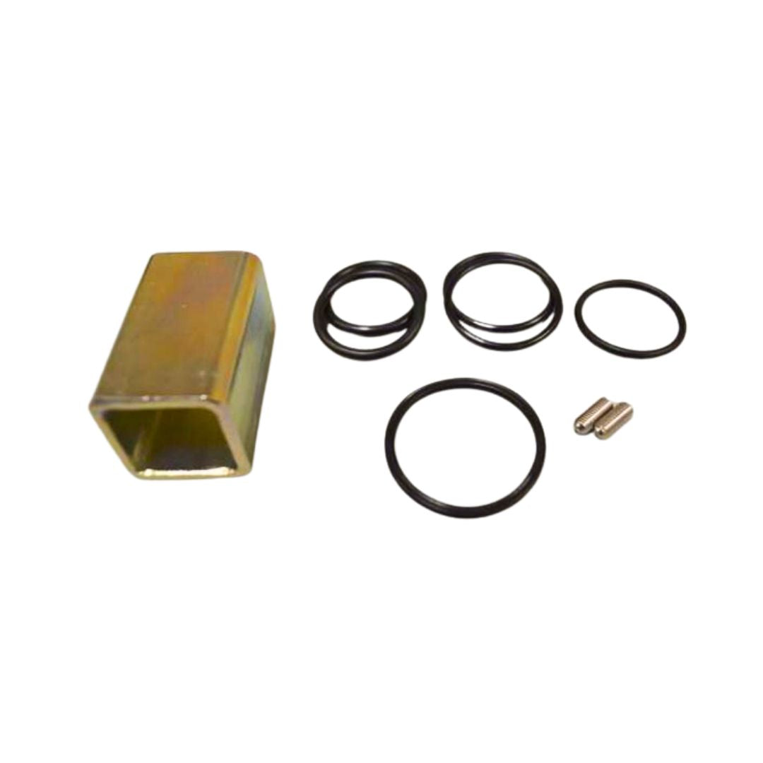 A metallic rectangular component, four black O-rings of various sizes from the Squibb Taylor Flo-Max Safety Coupler O-Ring Repair Kit with Tool (FM125-0022), and two small cylindrical metallic pieces on a white background.