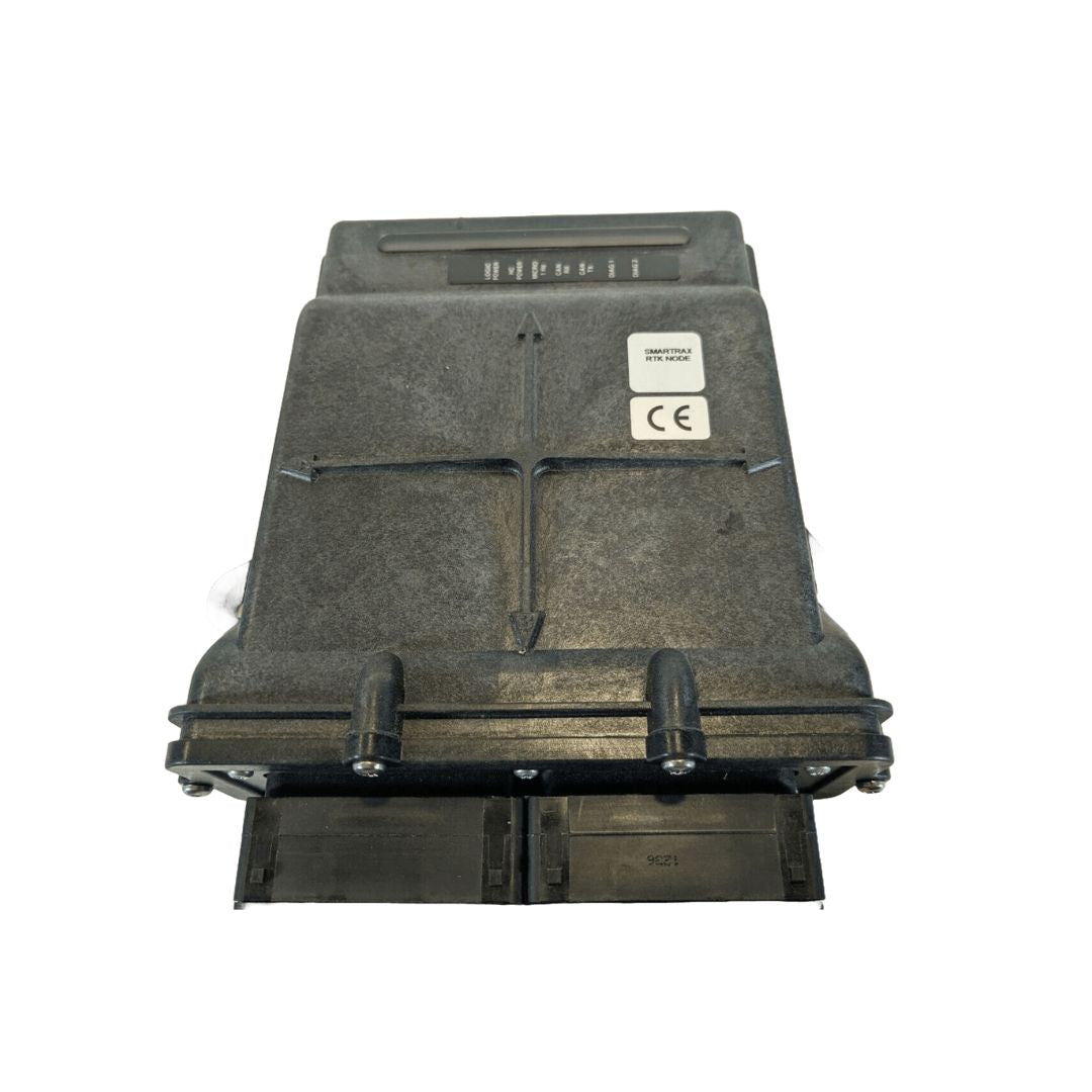 A rectangular, black electronic device featuring screws and ports, as well as a label with text and a CE mark on a white background—it's the Raven SmarTrax Control Node RTK - High-Precision Auto-Steering (063-0173-228), used in agricultural equipment for precision steering control.