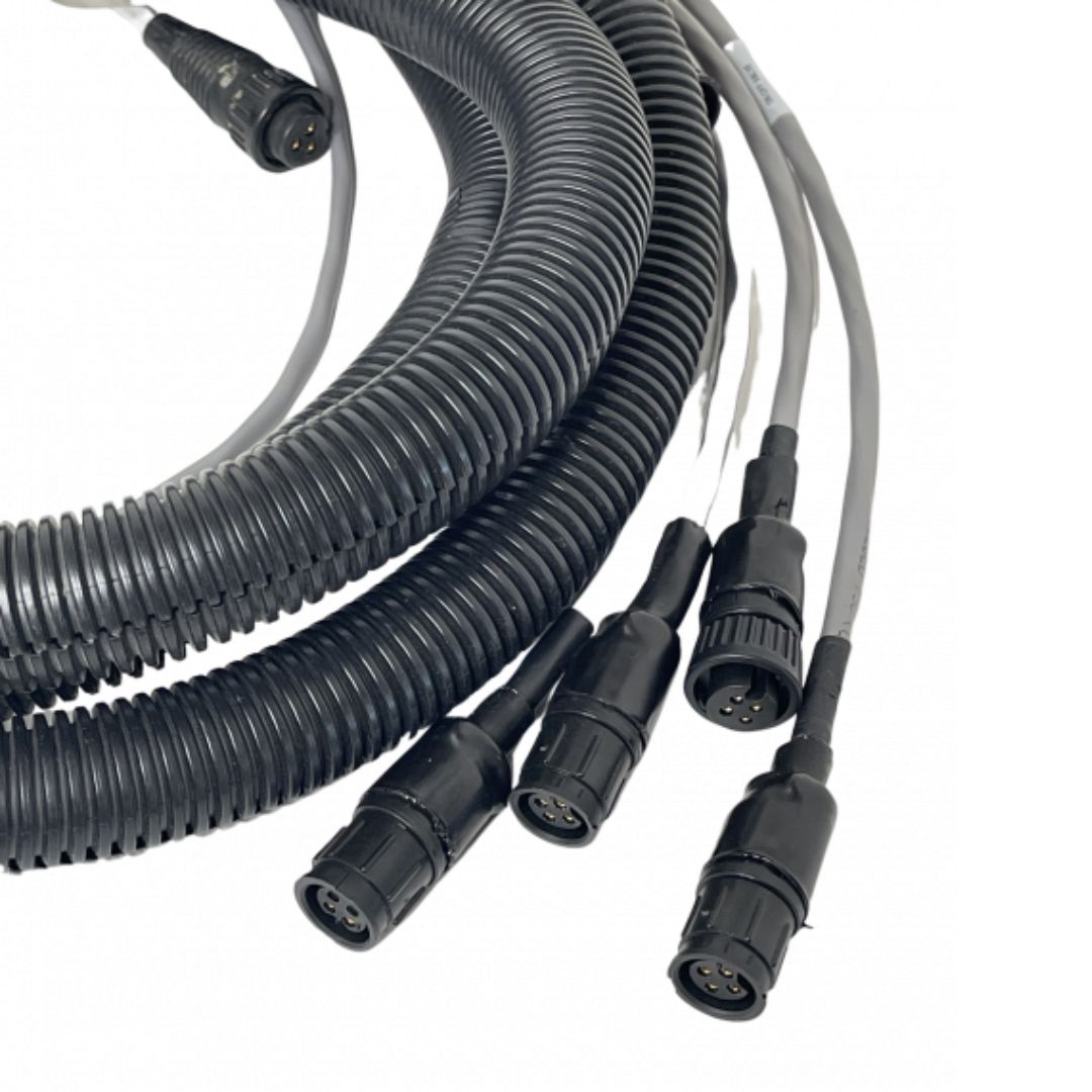 The Raven Flow Cable 3 Section 12' NH3 for Flow Meter & Fast Valve by Raven, featuring coiled wires with multiple black connectors and cables extended from one end, arranged on a white background, is ideal for NH3 systems integration.
