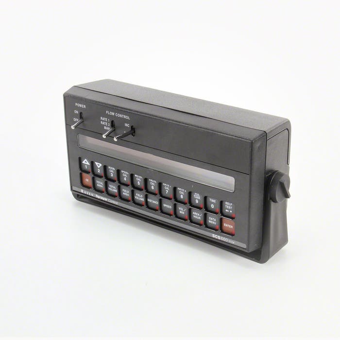 The Raven SCS 660 Spray Control Console - 7 Boom Liquid/Granular (Serial 063-0171-221) by Raven is a vintage black electronic device featuring a numeric keypad, display screen, control knob, and flow control switches on top. It is ideal for rate control tasks, offering the perfect blend of functionality and classic design.