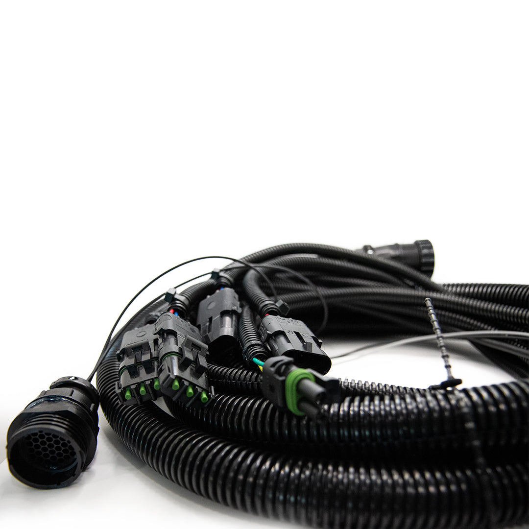 Coiled black electrical cables with connectors and protective coverings, including the Raven Cable 12' Extension SCS, are arranged on a white background.