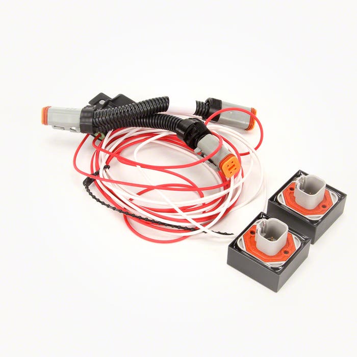 Coiled electrical wiring with connectors and two black and white plastic socket components on a clean, white background, ideal for integration into precision agriculture systems using the Raven CANbus Power Adapter Kit - With Terminators (117-0159-923) by Raven.