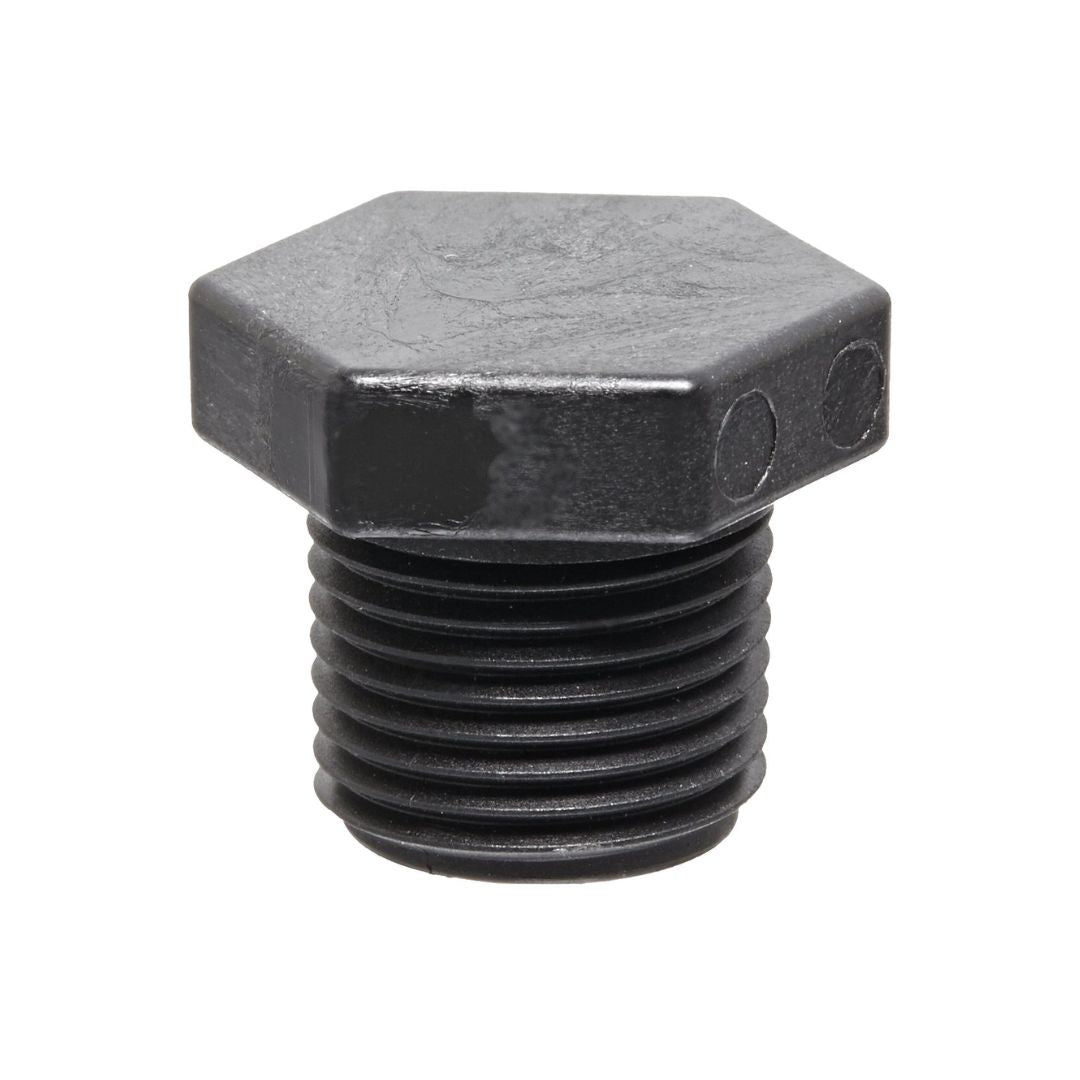 Standing upright against a white background, the Banjo 3/4" MPT Poly Pipe Plug (PLUG075) evokes an industrial strength with its black hexagonal design and threaded end.