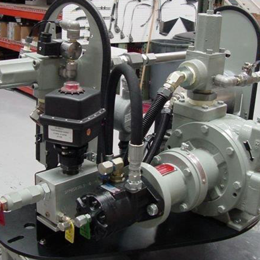 Close-up of an industrial hydraulic pump system with hoses and valves in a workshop setting.